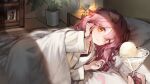  1girl absurdres animal_ears arknights bed_sheet black_camisole camisole cat_ears cat_girl cocktail_glass cup doctor_(arknights) drinking_glass floppy_ears goldenglow_(arknights) hair_between_eyes hand_in_own_hair highres holding holding_cup libiadan lying on_bed on_side pajamas photo_(object) pillow pink_hair pov yellow_eyes 
