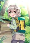  1girl :d absurdres ao_(flowerclasse) backpack bag bangs brown_skirt bush commentary_request day from_behind green_eyes green_shirt grey_hair grey_pantyhose hair_between_eyes hair_ornament hairclip highres holding_strap long_sleeves looking_at_viewer looking_back outdoors pantyhose shirt skirt smile solo tree yama_no_susume yukimura_aoi 