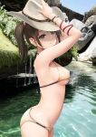  1girl absurdres arms_up bikini blue_eyes breasts brown_bikini brown_hair brown_headwear closed_mouth commentary_request cowboy_hat cowboy_shot day gibun_(sozoshu) hair_ornament hand_on_headwear hat highres medium_breasts original outdoors river short_hair solo standing swimsuit twintails water 