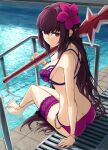  1girl ass bare_shoulders bikini breasts cleavage fate/grand_order fate_(series) hair_ornament highres holding jewelry kamo_ashi large_breasts long_hair looking_at_viewer official_alternate_costume pool purple_hair red_eyes scathach_(fate) scathach_(swimsuit_assassin)_(fate) smile solo swimsuit weapon 