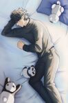  1boy absurdres black_hair black_pants black_shirt feet_out_of_frame highres kyuujitsu_no_warumono-san leung_k_t long_sleeves lying male_focus on_bed on_side pants pillow pointy_ears robot_cat shirt solo stuffed_animal stuffed_panda stuffed_toy warumono-san 