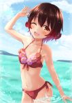  1girl bare_arms bare_shoulders bikini blush brown_eyes brown_hair collarbone cowboy_shot day groin hair_between_eyes highres kantai_collection mutsuki_(kancolle) navel ocean one_eye_closed ootori_(kyoya-ohtori) open_mouth red_bikini short_hair smile solo stomach swimsuit twitter_username 