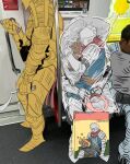  192_saioma 1other 2boys ambiguous_gender armor bag breastplate chosen_undead dakimakura_(object) dark_souls_(series) dark_souls_i full_armor full_body gauntlets gold_armor highres holding holding_sword holding_weapon knight knight_lautrec_of_carim leg_armor multiple_boys photo_background pillow plastic_bag qr_code shotel sitting standing sword train_interior weapon 