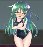  1girl black_one-piece_swimsuit blush breasts collarbone covering covering_breasts cowboy_shot crescent crescent_hair_ornament embarrassed green_eyes green_hair hair_between_eyes hair_ornament highres indoors kantai_collection long_hair looking_at_viewer nagatsuki_(kancolle) open_mouth pink_background school_swimsuit small_breasts solo swimsuit white_background yuuji_(itadon) 