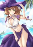  1girl beach breasts brown_hair cleavage clothing_cutout commentary genshin_impact green_eyes hand_on_headwear hat hato_74 highres large_breasts leaning_forward lisa_(genshin_impact) long_hair looking_at_viewer midriff navel palm_tree parted_lips purple_headwear purple_sarong sarong shoulder_cutout smile solo swimsuit tree witch_hat 