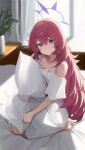  1girl absurdres blue_archive fluffy_hair grey_eyes hair_between_eyes halo highres hugging_object indoors iroha_(blue_archive) long_hair looking_at_viewer nightgown on_bed pillow pillow_hug purple_halo red_hair solo user_505240092 white_nightgown 