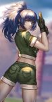  1girl adjusting_clothes adjusting_gloves ass black_gloves blue_eyes blue_hair blurry blurry_background earrings gloves green_jacket green_shorts highres hua-j jacket jewelry leona_heidern looking_at_viewer military military_uniform ponytail shorts snk solo the_king_of_fighters the_king_of_fighters_xv triangle_earrings uniform 