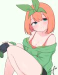  1girl bangs bare_shoulders black_shorts blue_eyes blush breasts cleavage collarbone commentary_request controller eyebrows_hidden_by_hair feet_out_of_frame game_controller go-toubun_no_hanayome green_background green_hoodie green_ribbon grin hair_between_eyes hair_ribbon head_tilt highres holding hood hood_down hoodie knees_up kujou_karasuma looking_at_viewer medium_breasts nakano_yotsuba off_shoulder orange_hair ribbon short_shorts shorts signature simple_background smile solo 