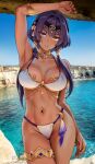  1girl arm_up armlet bikini blue_eyes breasts candace_(genshin_impact) dark-skinned_female dark_skin day foxyreine genshin_impact heterochromia highres jewelry large_breasts long_hair looking_at_viewer low_twintails navel neck_ring ocean outdoors parted_lips photo_background purple_hair solo stomach swimsuit thigh_gap thighlet thighs twintails yellow_eyes 