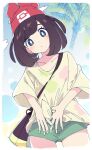  1girl bag beanie blue_eyes blush bright_pupils brown_hair closed_mouth collarbone green_shorts hat ixy long_hair looking_at_viewer outdoors palm_tree pokemon pokemon_(game) pokemon_sm raglan_sleeves red_headwear selene_(pokemon) shirt short_hair shorts solo thighs tied_shirt tree white_pupils 