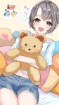  1girl blush calendar_(object) cushion denim denim_shorts doll_hug grey_hair highres idolmaster idolmaster_cinderella_girls indoors looking_at_viewer navel object_hug otokura_yuuki photo_(object) short_hair short_shorts shorts smile solo stuffed_animal stuffed_toy teddy_bear yuukura_yuu 