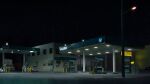  absurdres box_truck building car chloride_li commentary gas_pump gas_station highres lamppost motor_vehicle night no_humans original outdoors road scenery shop sparkle truck 