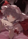  1girl bat_wings black_wings bow closed_mouth fingernails hat hat_ribbon highres kerok_(joniko1110) lying mob_cap on_stomach purple_hair red_bow red_eyes remilia_scarlet ribbon shirt short_hair short_sleeves smile solo touhou waist_bow white_headwear white_ribbon white_shirt wings wrist_cuffs 