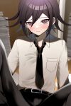  1boy alternate_costume bangs belt black_belt black_hair black_necktie black_pants blush book breast_pocket brown_eyes collared_shirt danganronpa_(series) danganronpa_v3:_killing_harmony flipped_hair grey_shirt hair_between_eyes highres knee_up male_focus medium_hair necktie ouma_kokichi pants pocket shiny shiny_hair shirt shirt_tucked_in smile solo urami0310 