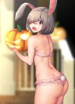  1girl absurdres animal_ears ass bare_shoulders bikini blurry blurry_background blush brown_hair cowboy_shot depth_of_field eating food food_on_face hair_over_one_eye highres holding holding_food holding_pumpkin holding_vegetable jack-o&#039;-lantern looking_at_viewer nicchi night open_mouth original outdoors pink_bikini pumpkin rabbit_ears rabbit_girl rabbit_tail red_eyes short_hair solo sweatdrop swimsuit tail vegetable wide-eyed 