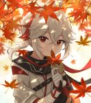  1boy armor bandages bangs black_gloves closed_mouth fingerless_gloves genshin_impact gloves grey_hair hair_between_eyes highres holding japanese_armor japanese_clothes kaedehara_kazuha leaf male_focus maple_leaf multicolored_hair panri ponytail red_eyes red_hair short_hair smile solo streaked_hair 