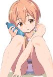  1girl bikini bottle bottle_to_cheek hair_between_eyes highres holding holding_bottle hoshizora_rin knees_up looking_at_viewer love_live! love_live!_school_idol_project orange_hair parted_lips sen_(sen0910) short_hair simple_background sitting solo swimsuit wet white_background yellow_eyes 