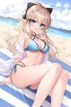  1girl :d absurdres ass_visible_through_thighs bangs beach beach_mat bikini blonde_hair blue_bikini blue_eyes breasts cleavage commentary elf fanteam feet_out_of_frame highres looking_at_viewer navel open_clothes pointy_ears ponytail princess_connect! saren_(princess_connect!) sidelocks sky smile solo swimsuit thighs 