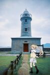  1girl :d black_shoes black_socks blonde_hair blush commentary day floating_hair from_behind green_eyes hair_ornament highres kagawa_prefecture kneehighs lighthouse loafers long_hair looking_at_viewer looking_back miniskirt mixed_media nujii ogijima_island open_mouth outdoors photo_background pleated_skirt puffy_short_sleeves puffy_sleeves sailor_collar school_uniform serafuku shoe_soles shoes short_sleeves sidelocks skirt smile socks solo standing summer_pockets summer_pockets_school_uniform sweater_vest tsumugi_wenders twintails very_long_hair white_sailor_collar white_skirt wide_shot x_hair_ornament yellow_sweater_vest 