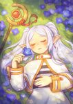  1girl absurdres artist_name blue_flower capelet closed_eyes commentary day elf flower frieren grass grey_hair highres holding holding_flower kaaileen long_hair lying on_back outdoors pointy_ears skirt sleeping solo sousou_no_frieren staff twintails untranslatable_commentary upper_body white_capelet white_skirt 