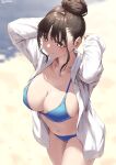  1girl arms_behind_head aya_(jonsun) beach bikini blue_bikini breasts brown_eyes brown_hair closed_mouth collarbone commentary_request from_above hair_bun jacket jonsun large_breasts looking_away mole mole_on_breast navel open_clothes open_jacket original sand short_hair sidelocks single_hair_bun smile solo swimsuit twitter_username white_jacket 