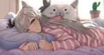  1girl as4gi backlighting bangs blue_eyes blush braid braided_bangs cactus cone_hair_bun day grey_eyes grey_hair hair_bun head_on_pillow hololive hololive_indonesia hood hooded_pajamas indoors long_hair long_sleeves looking_at_viewer lying object_hug on_bed on_stomach pajamas pillow pillow_hug plant potted_plant signature smile solo striped striped_pajamas swept_bangs upper_body vestia_zeta virtual_youtuber window 