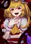  1girl :d absurdres arm_under_breasts ascot bangs blonde_hair blurry blush crystal depth_of_field fangs flandre_scarlet hair_between_eyes hand_up hat highres izanaware_game laevatein_(touhou) laughing looking_at_viewer medium_hair mob_cap nail_polish open_mouth outer_glow perspective puffy_short_sleeves puffy_sleeves red_background red_eyes red_nails red_skirt red_vest short_sleeves skirt skirt_set sleeves_past_wrists smile solo teeth tongue touhou upper_body vest wings wrist_cuffs yellow_ascot 