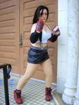  brown_hair cosplay final_fantasy final_fantasy_vii leather pale punch short_skirt suspenders tifa_lockhart 