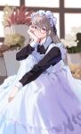  1girl absurdres apron bangs closed_mouth dress glasses hand_on_own_cheek hand_on_own_face highres knees_up long_hair long_sleeves looking_at_viewer maid maid_apron maid_headdress original plant potted_plant red_eyes sitting solo yamiiv 
