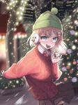  1girl bangs blonde_hair blue_eyes christmas christmas_lights christmas_ornaments christmas_tree fur_trim gift hair_ornament hat highres hololive hololive_english looking_at_viewer monocle_hair_ornament necktie open_mouth short_hair smile solo string_of_light_bulbs sweater virtual_youtuber watson_amelia zedd_(zedgawr) 