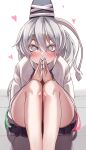  1girl @_@ absurdres bangs bare_legs blush commentary_request eyelashes eyes_visible_through_hair feet_out_of_frame fingernails grey_eyes grey_hair hair_between_eyes hand_to_own_mouth hands_up hat heart highres japanese_clothes kariginu knees_up legs long_hair long_sleeves looking_at_viewer maboroshi_mochi mononobe_no_futo nail_polish own_hands_together ponytail sitting skirt solo staring tate_eboshi touhou wide-eyed 