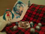  1girl 2d_dating bauble blue_hair cookie dakimakura_(object) figure food gift hat hatsune_miku heart highres long_hair non-web_source photo_(medium) pillow plaid plate santa_costume santa_hat solo twintails under_covers very_long_hair vocaloid 