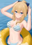  1girl absurdres arms_up bangs bikini blonde_hair blue_bow blue_eyes blush bow commentary_request genshin_impact grin hair_between_eyes hair_bow highres innertube jean_(genshin_impact) long_hair looking_at_viewer navel sidelocks simobulanka smile solo stomach striped striped_bikini swimsuit water 