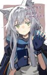 1girl animal_ear_fluff animal_ears arknights bangs blue_gloves book border brown_background cat_ears exion_(neon) fingerless_gloves gloves green_eyes grey_hair head_tilt highres holding holding_book long_hair looking_at_viewer new_year rosmontis_(arknights) shirt simple_background smile solo upper_body waving white_border white_shirt 