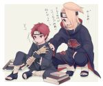  2boys aged_down akatsuki_uniform annoyed bandaged_leg bandages black_nails blonde_hair blue_eyes book book_stack deidara_(naruto) full_body hand_on_another&#039;s_shoulder highres male_focus marionette multiple_boys naruto_(series) naruto_shippuuden ninja ponytail puppet red_hair sasori_(naruto) smile squatting translation_request wowishi 