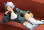  1girl :q absurdres asticassia_school_uniform blush breasts commentary_request couch elbow_rest feet_out_of_frame green_jacket green_shorts grey_hair gundam gundam_suisei_no_majo head_rest highres jacket large_breasts licking_lips looking_at_viewer lying on_side sasayama_(ushijimaxxxxx) school_uniform secelia_dote short_hair short_shorts shorts skindentation solo thighhighs thighs tongue tongue_out v-shaped_eyebrows wavy_hair white_thighhighs 