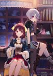  2girls arm_support atelier_(series) atelier_resleriana atelier_sophie black_dress black_gloves blue_coat bookshelf boots brown_boots brown_corset closed_mouth coat commentary_request cookie copyright_notice corset crystal cup desk dress eating food frilled_skirt frills gloves grey_hair hair_ornament highres holding holding_cup jewelry johanna_(atelier) medium_hair multiple_girls necklace noco_(adamas) official_art open_clothes open_coat red_eyes red_hair red_skirt saucer second-party_source short_hair sitting skirt smile sophie_neuenmuller teacup thigh_strap window 