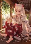 1girl arm_belt bangs barefoot bow cigarette closed_mouth collared_shirt commentary_request footwear_bow fujiwara_no_mokou full_body grey_shirt hair_bow hand_on_ground highres holding holding_cigarette ichita_(yixisama-shihaohaizhi) indian_style long_hair long_sleeves looking_at_viewer ofuda ofuda_on_clothes outdoors pants ponytail porch red_eyes red_footwear red_pants shirt shoes shoes_removed sitting smoke solo suspenders touhou very_long_hair white_bow white_hair 
