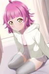  1girl absurdres ahoge blush closed_mouth curtains grey_thighhighs highres hood hooded_jacket jacket looking_at_viewer love_live! love_live!_nijigasaki_high_school_idol_club medium_hair pink_hair sitting skirt smile solo tennoji_rina thighhighs thighs yellow_eyes zanpon zettai_ryouiki 