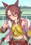  1girl animal_ears blue_eyes blush brown_hair clothes_around_waist commentary_request day denim ear_ornament grin hair_between_eyes hand_on_hip highres horse_ears horse_girl horse_tail horseshoe horseshoe_ornament jacket looking_at_viewer midriff nametake narita_taishin_(umamusume) open_clothes open_jacket outdoors pink_jacket smile solo sweat tail torn_clothes umamusume 