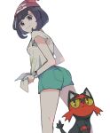  1girl ass atsumi_yoshioka bangs beanie black_hair bracelet closed_mouth commentary_request eyelashes from_below green_shorts grey_eyes hat jewelry litten looking_down pokemon pokemon_(creature) pokemon_(game) pokemon_sm red_headwear selene_(pokemon) shirt short_hair short_shorts short_sleeves shorts simple_background smile t-shirt tied_shirt white_background z-ring 