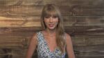 1girl bangs blonde_hair blue_eyes blunt_bangs earrings floral_print hair_over_shoulder jewelry lips long_hair looking_at_viewer non-web_source off-topic parted_lips real_life sleeveless solo stud_earrings taylor_swift teeth upper_body 