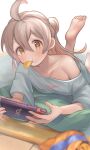  1girl :t bangs barefoot brown_eyes chips_(food) collarbone commentary copyright_name feet food food_in_mouth foot_up grey_hair hair_between_eyes handheld_game_console highres holding holding_handheld_game_console light_blush long_hair looking_at_viewer lying multicolored_hair nintendo_switch nyapanu on_stomach onii-chan_wa_oshimai! oversized_clothes oversized_shirt oyama_mahiro pink_hair potato_chips shirt short_sleeves single_bare_shoulder soles solo toes two-tone_hair 