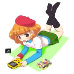  1girl bangs beret black_socks blue_shirt blush box brown_eyes brown_hair cartridge dot_nose game_boy game_boy_color green_skirt handheld_game_console hat heart heart_in_eye holding holding_handheld_game_console lying on_stomach open_mouth pop&#039;n_music red_wristband rie-chan shirt skirt socks solo symbol_in_eye umi_no_tarako white_shirt 