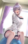  1girl ball bangs between_legs blush breasts exercise_ball hair_bun hair_ornament hand_between_legs highres indoors kaneki_yushi large_breasts long_sleeves looking_at_viewer open_mouth original shirt sitting smile solo x_hair_ornament 