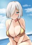  1girl bare_shoulders bikini blue_eyes blue_sky blurry blurry_background blush breasts cleavage closed_mouth cloud collarbone day grey_hair hair_ornament hair_over_one_eye hairclip hamakaze_(kancolle) highres horizon kantai_collection light_smile looking_at_viewer montemasa navel ocean outdoors short_hair sky solo strap_gap string_bikini swimsuit v_arms water 