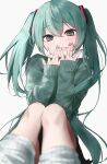  1girl alternate_costume aqua_eyes aqua_hair aqua_nails blush green_sweater grin halhalhalchan hands_over_own_mouth hatsune_miku highres knees_up leg_warmers simple_background smile solo sweater vocaloid white_background 
