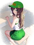  1girl alternate_costume alternate_hairstyle ass baseball_cap blush brown_hair camisole from_behind green_eyes green_headwear green_skirt hair_down hat hayakawa_tazuna highres holding holding_spoon horse_girl horseshoe_ornament long_hair looking_at_viewer looking_back pleated_skirt sitting skirt solo spoon umamusume white_camisole zenbrush2 