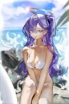  1girl bare_arms bare_legs bare_shoulders barefoot beach bikini blue_archive blush breasts cleavage collarbone day halo highres long_hair mechanical_halo navel ocean outdoors purple_eyes purple_hair renn_01 solo swimsuit tongue tongue_out two_side_up white_bikini yuuka_(blue_archive) 