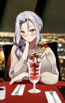  1girl alternate_costume birthday blush carmilla_(fate) chair closed_mouth commentary cup english_commentary fate/grand_order fate_(series) grey_hair head_rest highres long_hair long_sleeves looking_at_viewer monkey_jon mug ribbed_sweater side_ponytail sitting solo sweater table yellow_eyes 